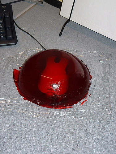 2000 Mercury Grand Marquis - A red gelatin mold sits on a desk next to a keyboard and office supplies.