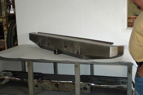 1993 Ford Bronco - A close-up view of a vehicle's rear bumper part resting on a table.