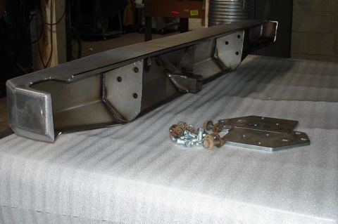 1993 Ford Bronco - Close-up of a vehicle's rear bumper section, showing a trailer hitch receiver and brackets.