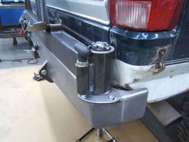 Rear bumper with tow hitch and visible trailer wiring connector