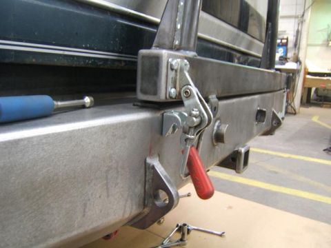 1993 Ford Bronco - Metal rear bumper assembly with a red tow hook visible.