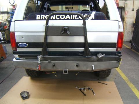 1993 Ford Bronco - The rear of a white SUV is shown, focusing on the bumper and tailgate area.