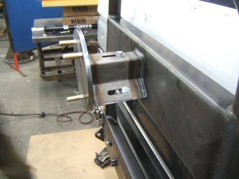 1993 Ford Bronco - A close-up view of a custom-fabricated metal bracket with protruding studs, attached to a vehicle's rear structure.