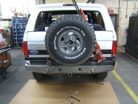 1993 Ford Bronco - Rear view of a 1993 Ford Bronco, a spare tire mounted on the back and a Hi-Lift jack attached.