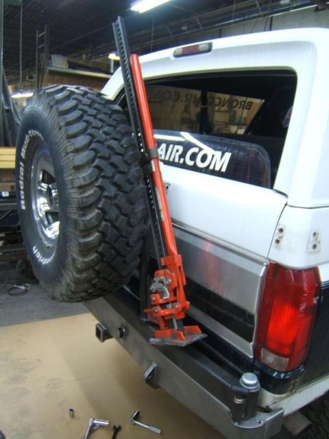 1993 Ford Bronco - Rear view of a 1993 Ford Bronco showing a spare tire and Hi-Lift jack mounted on the bumper.