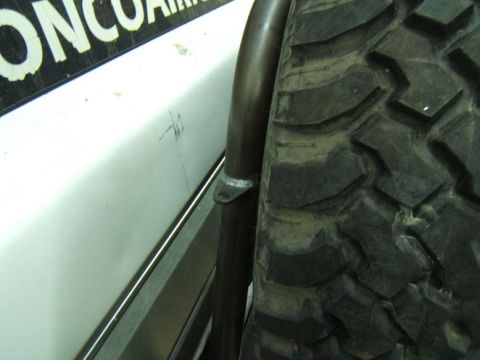 1993 Ford Bronco - Close-up of a vehicle's rear bumper and tire, with "BroncoAir" text on the body panel.
