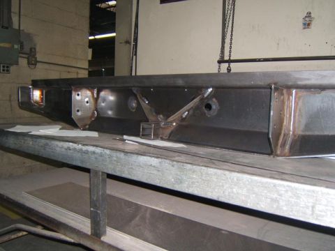 1993 Ford Bronco - A fabricated steel bumper is shown on a metal table, ready for installation.