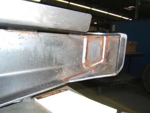 1993 Ford Bronco - Close-up view of a metal rear bumper section showing fabrication welds and signs of rust.