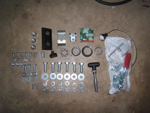 1993 Ford Bronco - Collection of hardware and parts laid out on a concrete surface.