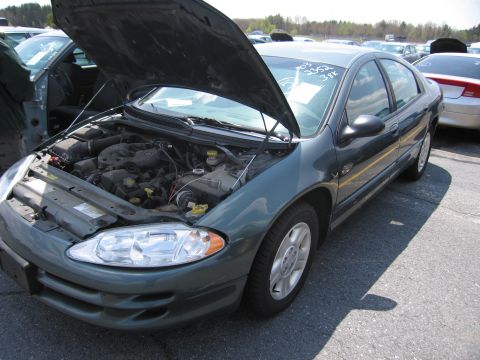 2001 Ford Crown Victoria - A dark green sedan is parked in a lot with its hood open, revealing the engine compartment.