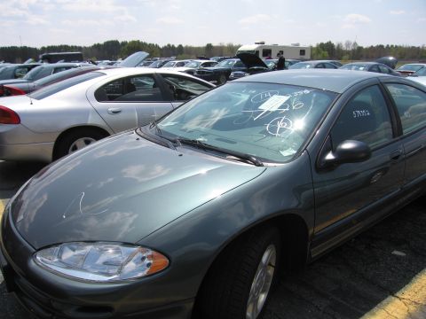2001 Ford Crown Victoria - Multiple vehicles are parked outdoors under a cloudy sky, with one sedan in the foreground showing windshield markings.