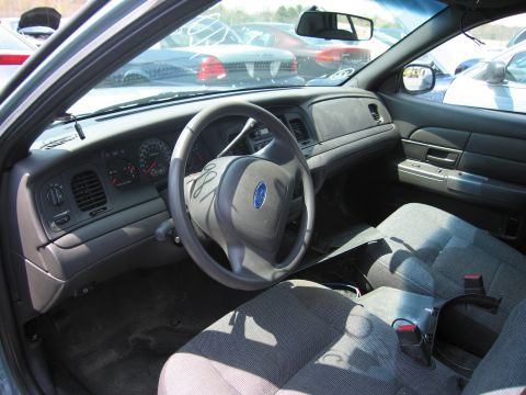 2001 Ford Crown Victoria - The interior of a Ford Crown Victoria is shown, with other vehicles in the background.