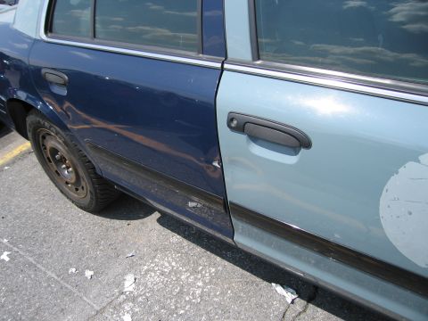 2001 Ford Crown Victoria - Side view of a two-tone Ford Crown Victoria police car door, showing the transition between the dark blue and light blue paint.