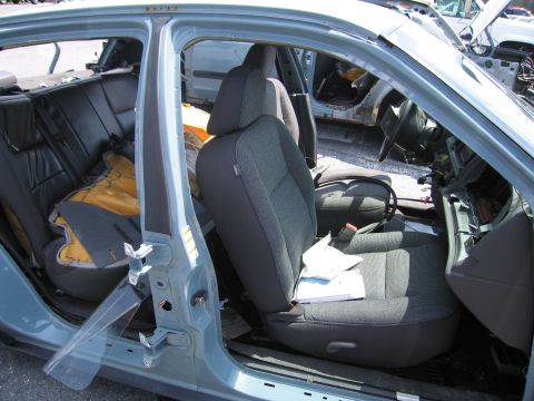 2001 Ford Crown Victoria - The interior of a light blue sedan shows signs of damage and disrepair, with documents scattered on the passenger seat.
