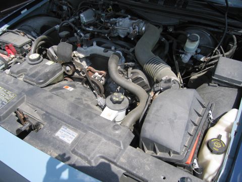 2001 Ford Crown Victoria - Engine bay of a 2001 Ford Crown Victoria, showing various components and hoses.