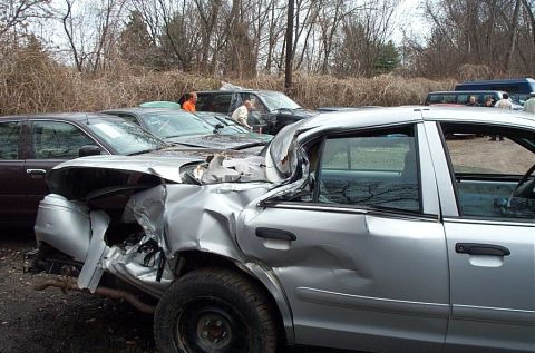 2001 Ford Crown Victoria - This silver sedan has sustained significant damage to its rear quarter panel and bumper.