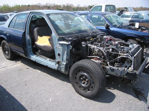 2001 Ford Crown Victoria - This 2001 Ford Crown Victoria is in a junkyard, missing its front end and some body panels.