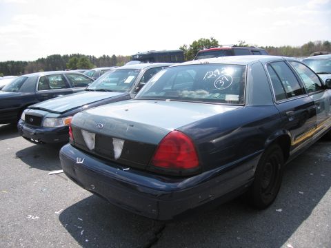 2001 Ford Crown Victoria - This 2001 Ford Crown Victoria, seen from the rear, features a two-tone paint scheme and a circled number 37 on the back window.