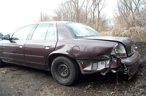 2001 Ford Crown Victoria - This 2001 Ford Crown Victoria shows significant damage to its rear quarter panel and front end.