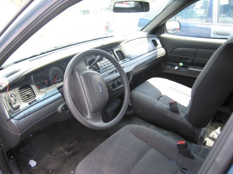 2001 Ford Crown Victoria - Interior view of a 2001 Ford Crown Victoria, highlighting the dashboard and seating.
