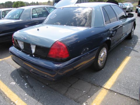 2001 Ford Crown Victoria - This 2001 Ford Crown Victoria is parked in a lot with yellow lines on the asphalt.