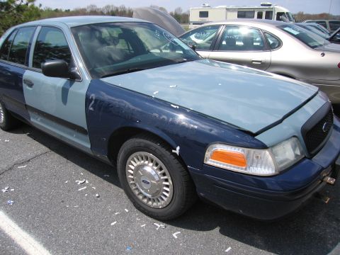 2001 Ford Crown Victoria - This two-tone Ford Crown Victoria has a dark blue front fender and hood, with a lighter blue door and rear quarter panel.