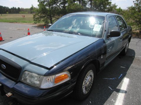 2001 Ford Crown Victoria - This Ford Crown Victoria has a two-tone paint job with a light blue hood and fenders and black lower body panels.