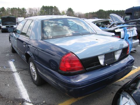 2001 Ford Crown Victoria - Rear view of a 2001 Ford Crown Victoria, showing its distinctive taillights and Ford badging.