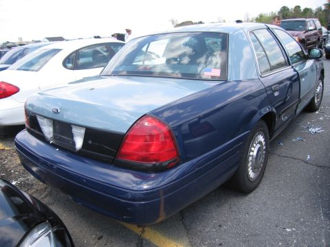 2001 Ford Crown Victoria - Rear view of a two-tone blue 2001 Ford Crown Victoria parked outdoors.