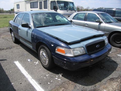 2001 Ford Crown Victoria - This 2001 Ford Crown Victoria police car has a two-tone paint scheme and the hood is open.