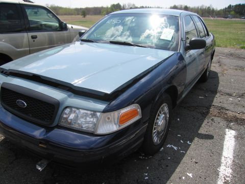 2001 Ford Crown Victoria - This 2001 Ford Crown Victoria is seen from a 3q-front angle, with a two-tone blue paint scheme and a paper on the windshield.