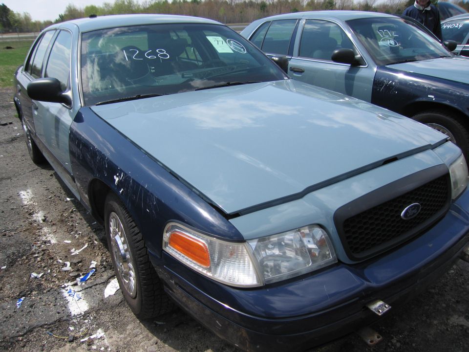 2001 Ford Crown Victoria front view with two-tone paint and another Crown Victoria behind it