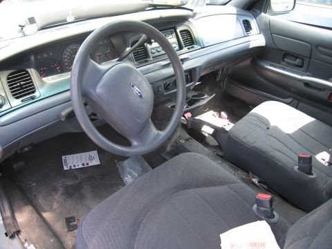 2001 Ford Crown Victoria - The interior of a 2001 Ford Crown Victoria, the dashboard, steering wheel, and front seats.