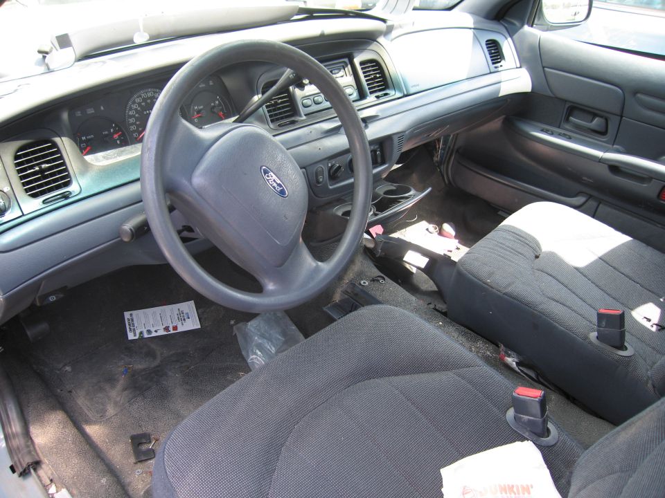 Interior of a 2001 Ford Crown Victoria showing dashboard, steering wheel, and seats