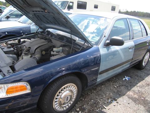 2001 Ford Crown Victoria - This Ford Crown Victoria has two-tone paint and the hood is open, revealing the engine compartment.