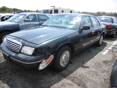 2001 Ford Crown Victoria - This 2001 Ford Crown Victoria sedan shows damage to its front passenger side headlight and bumper area.