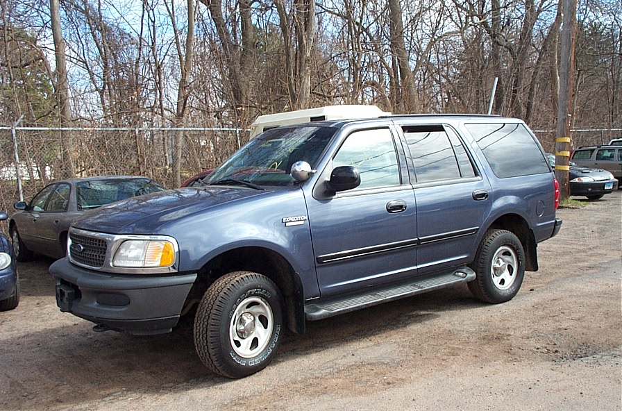Blue SUV parked outdoors, front 3/4 view. Appears to be a 2001 Ford Expedition