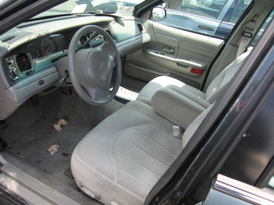 Interior view of a 2001 Ford Crown Victoria, showing the dashboard, steering wheel, and front seats