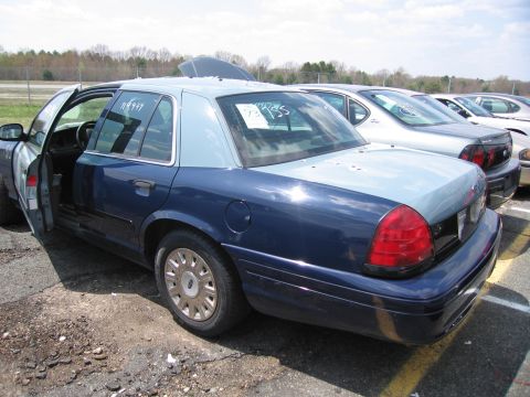 2001 Ford Crown Victoria - Photograph of a car in a lot, not a technical document.