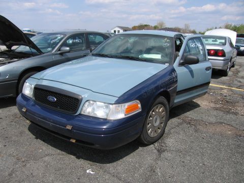 2001 Ford Crown Victoria - Photograph of a car in a lot, not a technical document.