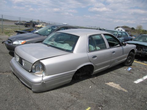 2001 Ford Crown Victoria - Photograph of a car in a lot, not a technical document.
