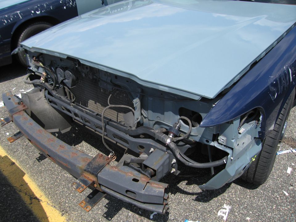 Front end of a sedan with bumper and hood removed showing radiator support