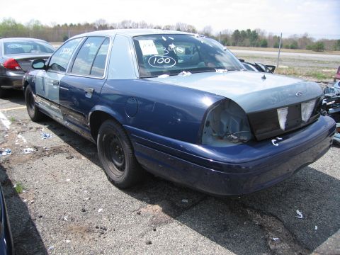2001 Ford Crown Victoria - Photograph of a car in a lot, not a technical document.