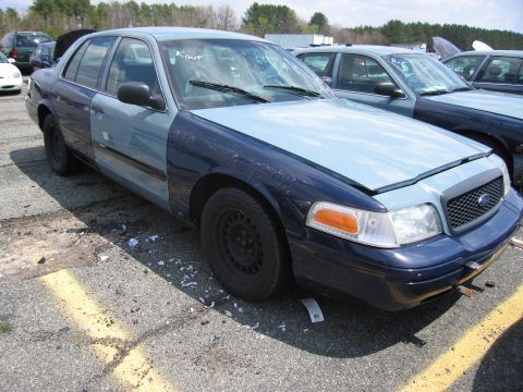 2001 Ford Crown Victoria - Photograph of a car in a lot, not a technical document.