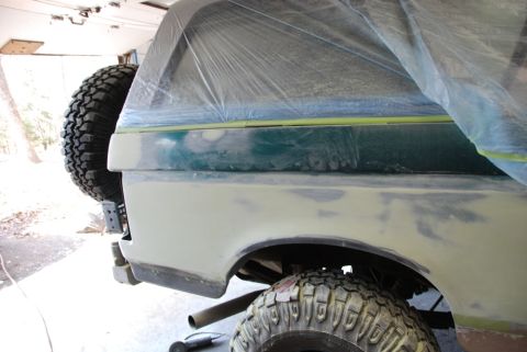 1996 Ford Bronco - Photograph of a masked truck bedside panel during paint prep, not a technical document.