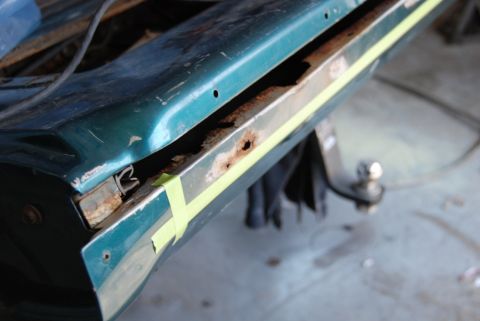 1996 Ford Bronco - Photograph of a corroded lower body panel seam during repair, not a technical document.