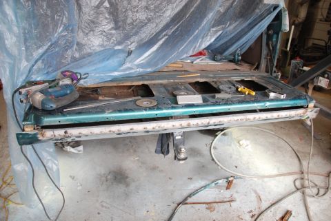 1996 Ford Bronco - Photograph of a truck bedside panel being worked on with power tools, not a technical document.