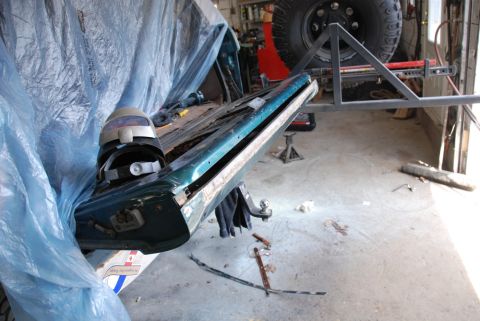 1996 Ford Bronco - Photograph of a removed vehicle body panel in a workshop during restoration, not a technical document.