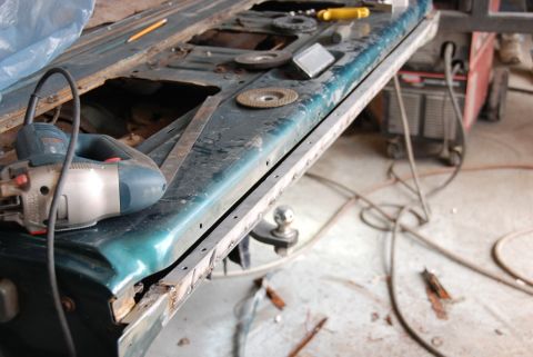 1996 Ford Bronco - Photograph of a vehicle body panel undergoing grinding and welding, not a technical document.