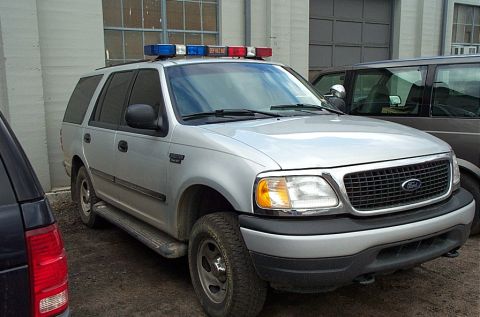 2001 Ford Crown Victoria - This Ford Expedition SUV appears to be equipped for police duty, with a light bar mounted on its roof.